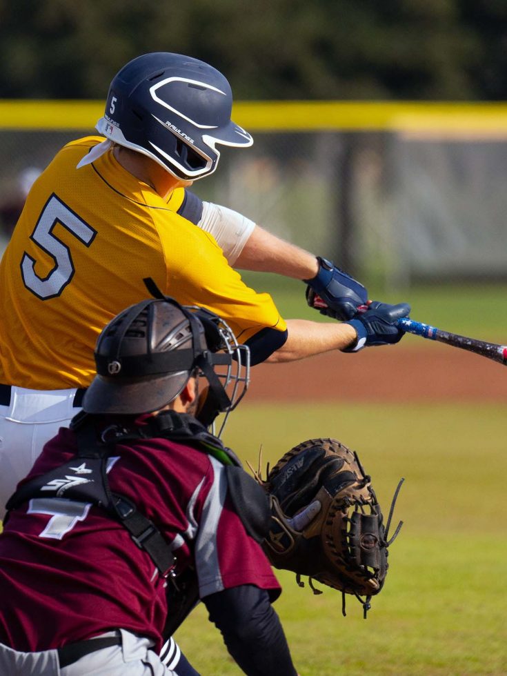 Merced college men's baseball batter hitting ball