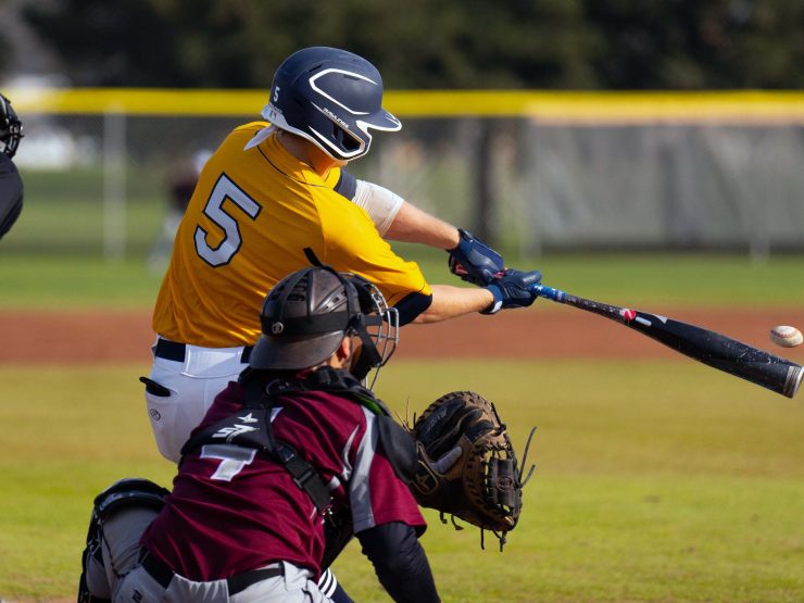 Merced college men's baseball batter hitting ball