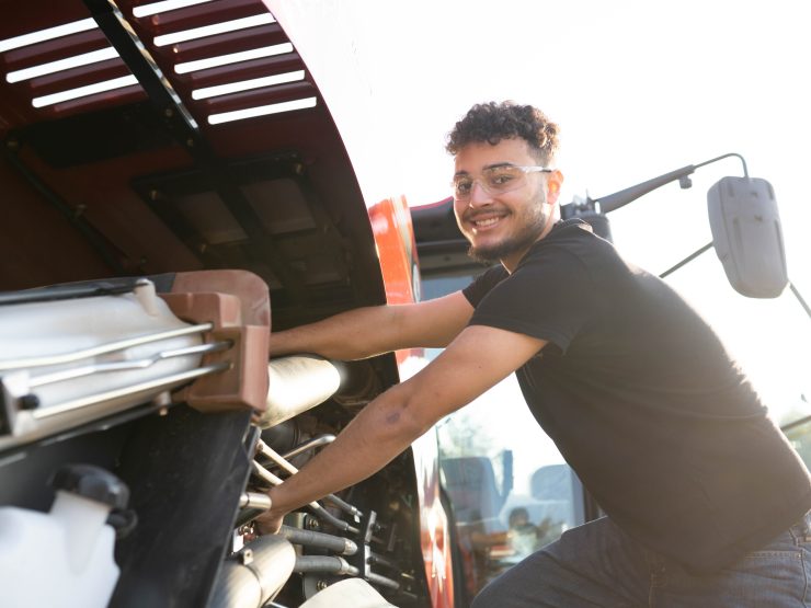 Student working on a tractor engine