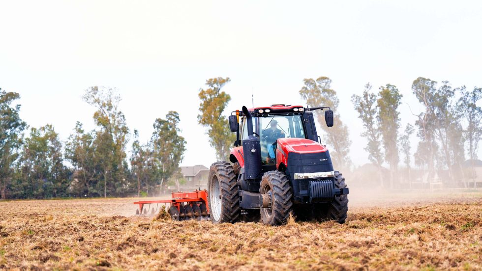 tractor plowing field on campus