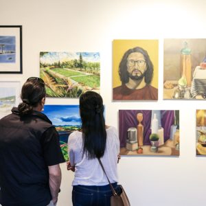 people viewing the campus art gallery