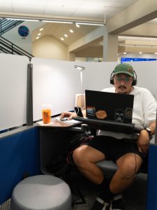 Student in a personal study pod, using their laptop for studying.