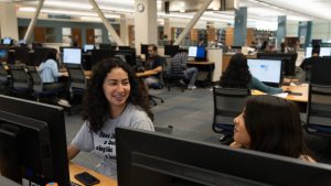 Computer lab with students working alone and together.