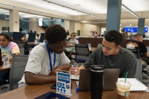 Two students engaged in one-on-one, in-person tutoring session.