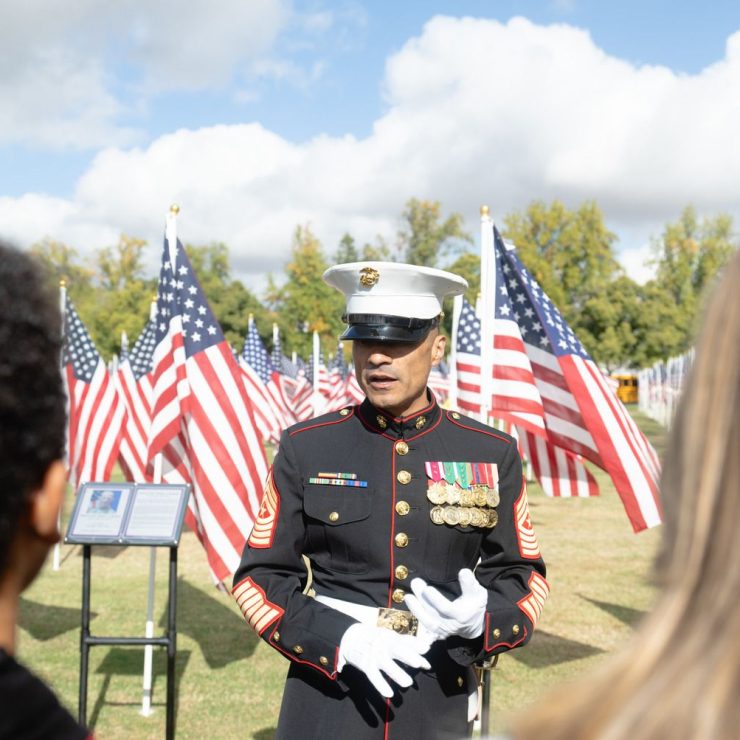 veteran talking to students at field of honor